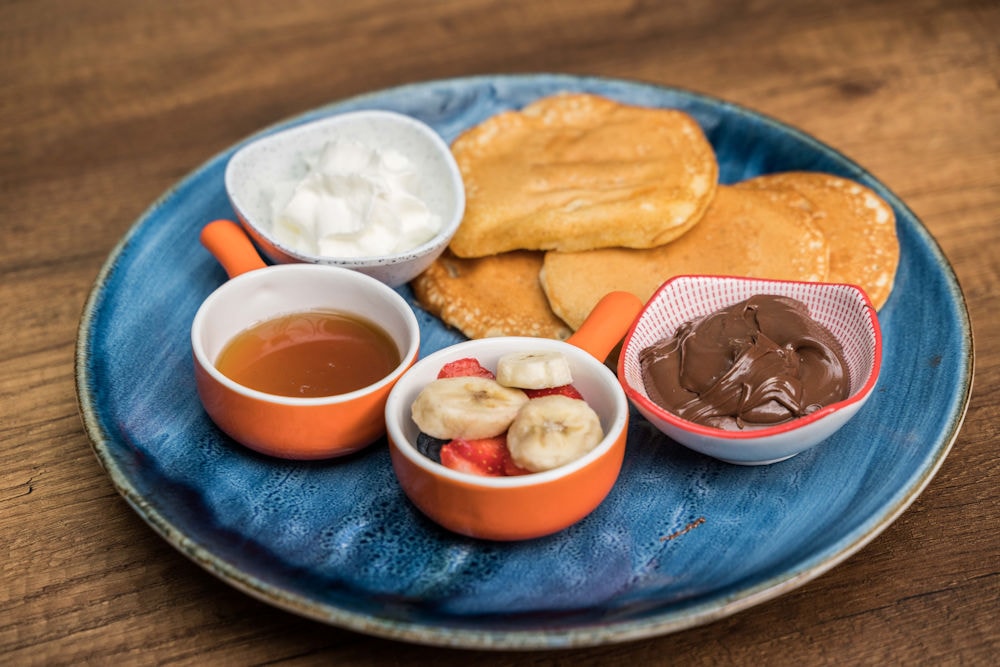 Pancakes with honey, Nutella, fruit and yogurt