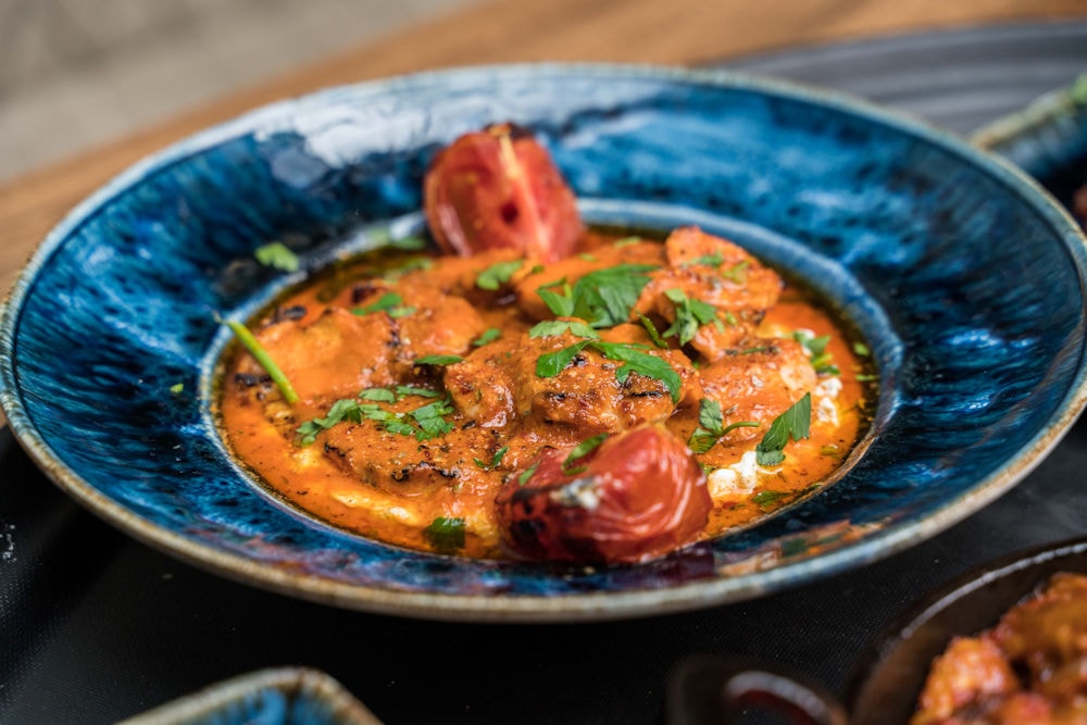 Spiced chicken in tomato sauce with roasted tomatoes