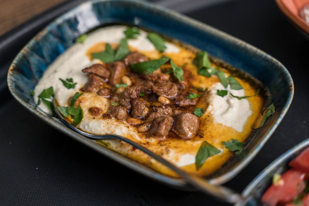 Spiced lamb with yogurt, pine nuts and herbs